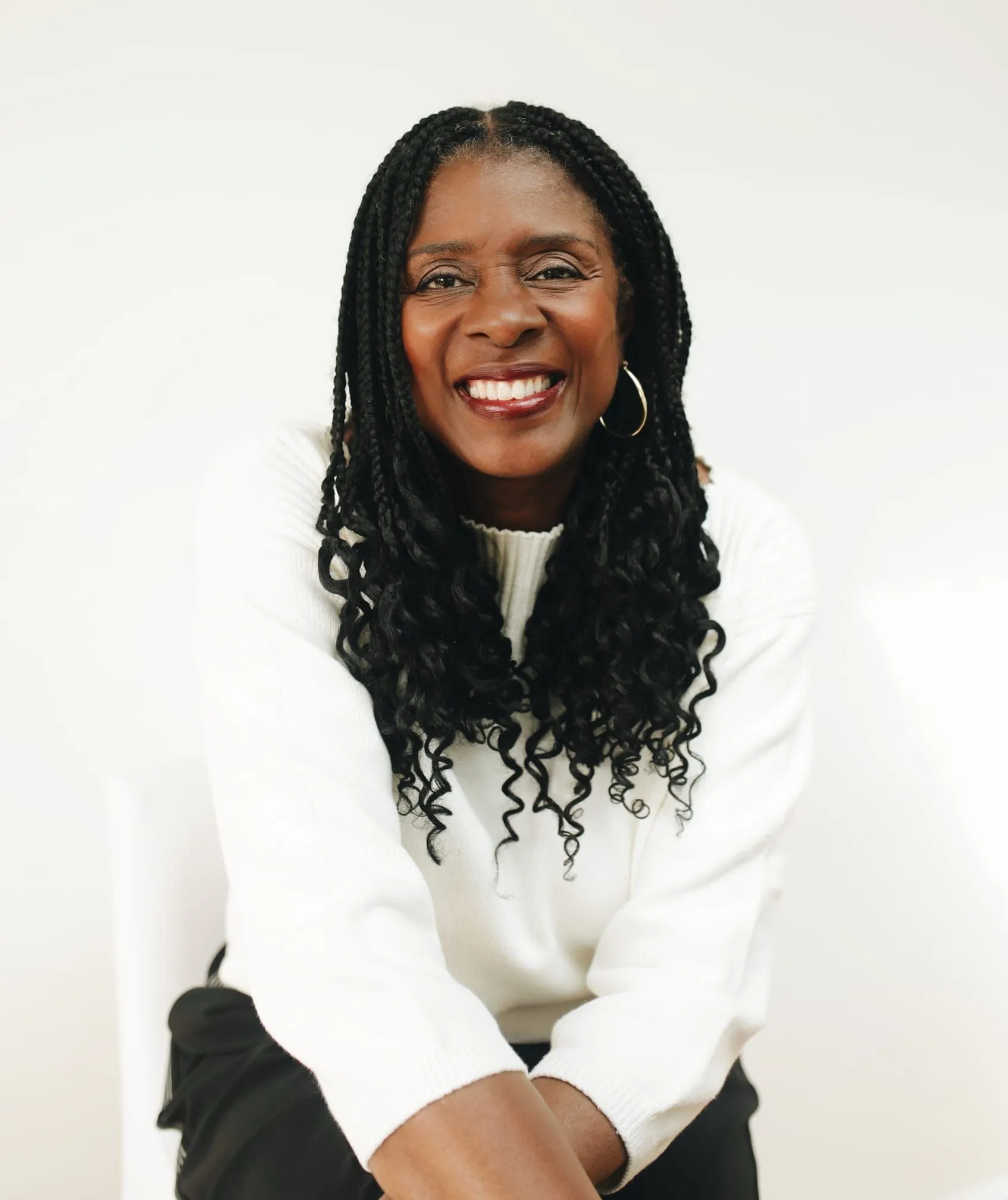 Lorraine Lee, smiling, in a cream jumper against a white background